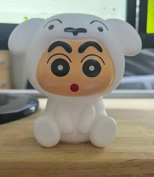 Cartoonish character figurine with a surprised expression on a wooden surface